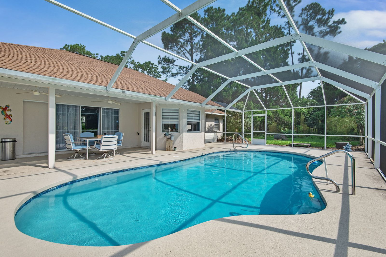 Screened-in pool and covered lanai at 62 Bayside Dr