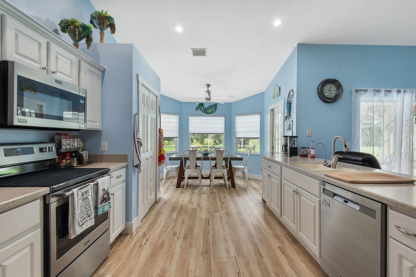 Kitchen and dining area with stainless appliances and bright natural light