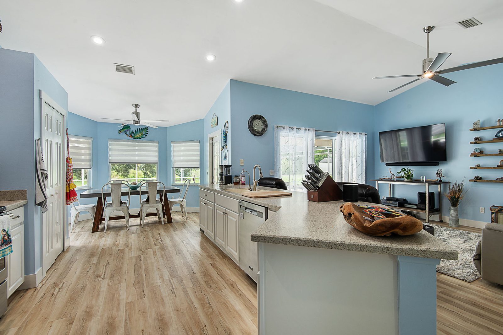 Living room and family space with vaulted ceiling and pool access