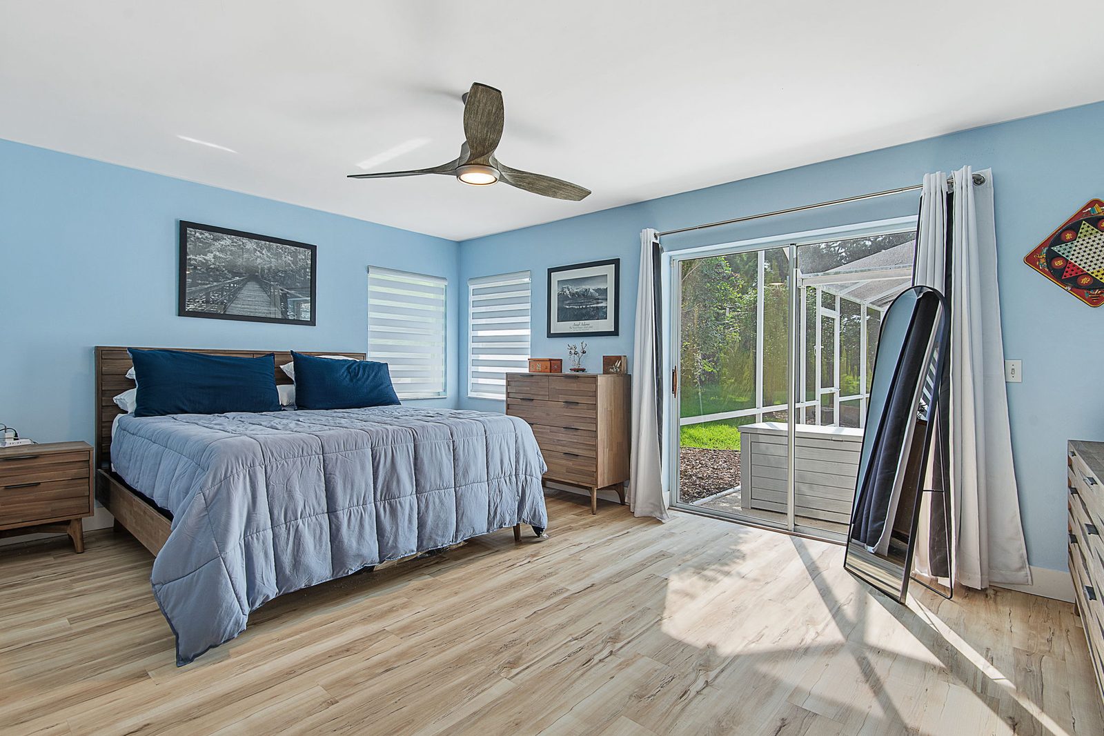 Primary bedroom with direct sliding-door access to the pool area